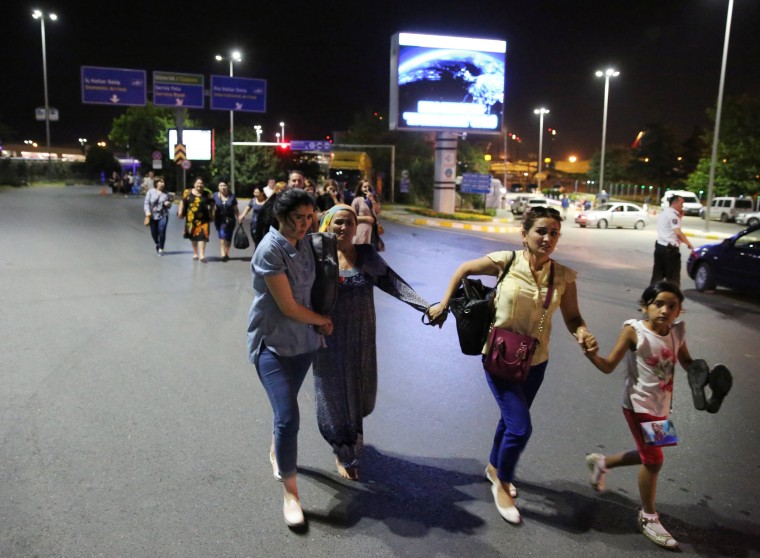 Image: People walk away from Istanbul Ataturk airport, Turkey