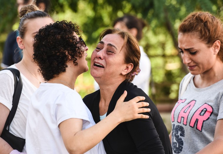 Image: A mother of victims reacts outside a forensic medicine building  in Istanbul