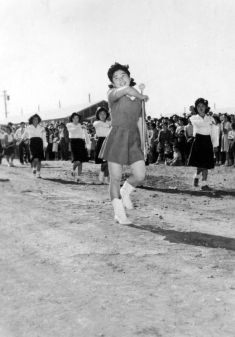 Patsy Yorita performing a flag salute at the Tule Lake concentration camp at the Independence Day parade. (1943)