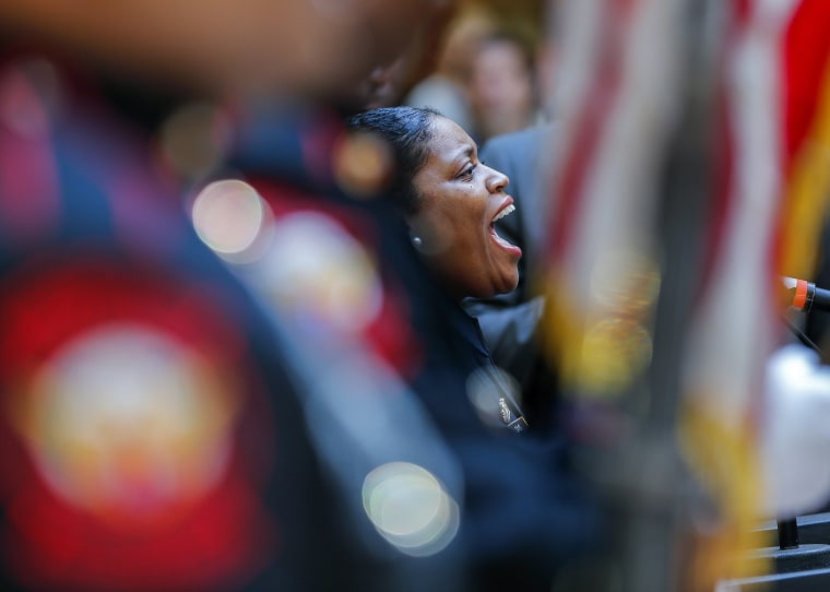 Image: US Customs and Border Protection officer Arrisia Sims sings the 'Star Spangled Banner' national anthem