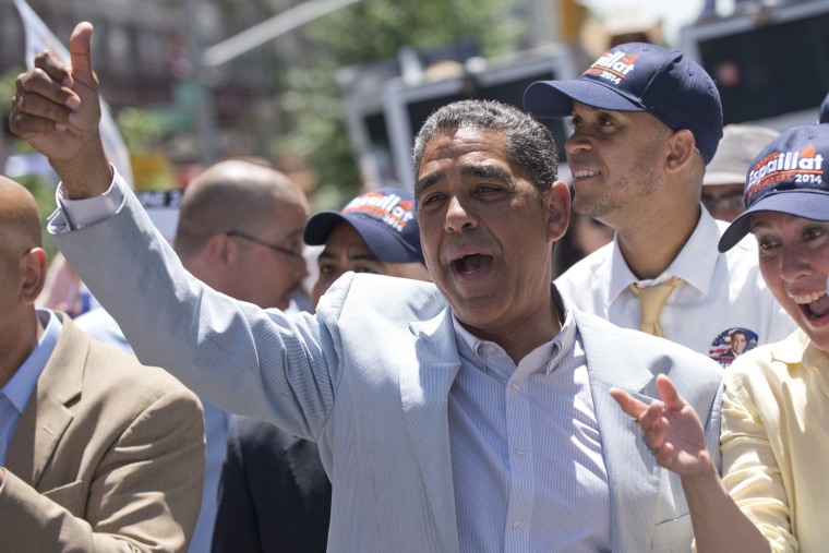 Image: Senator Adriano Espaillat sings while giving a thumbs up to supporters during a caravan to get out the vote in New York