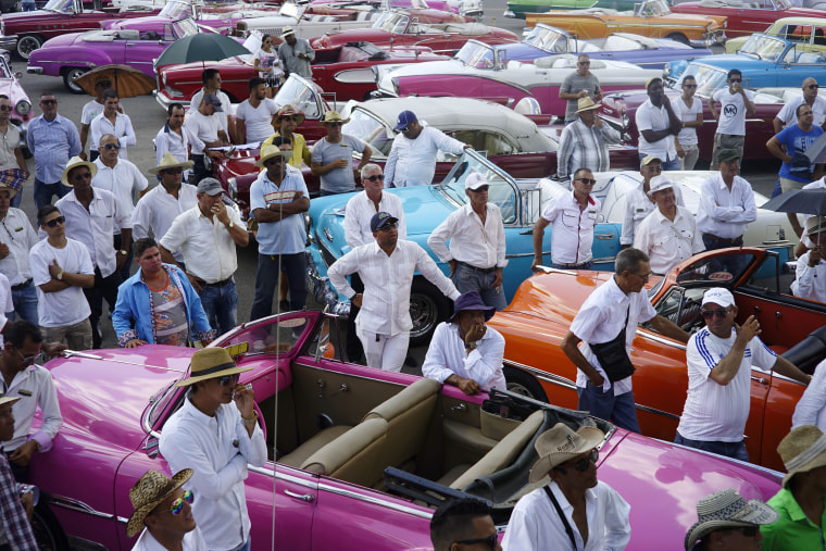Drivers of vintage American cars in Havana, Cuba.