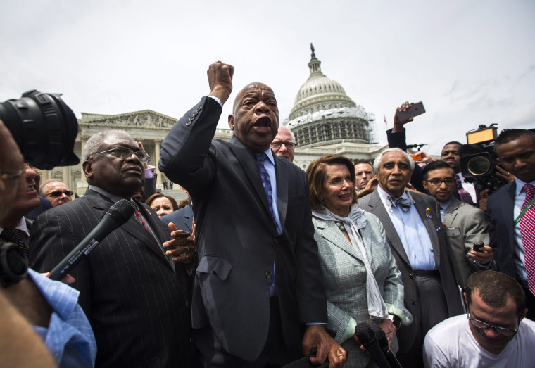 Image: Democratic Representative from Georgia John Lewis (C) speaks to supporters after Democratic House members held a sit-in