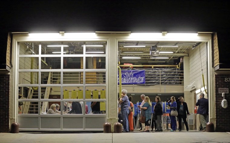 Image: Voters line up before daylight to cast their ballots in Cary, N.C