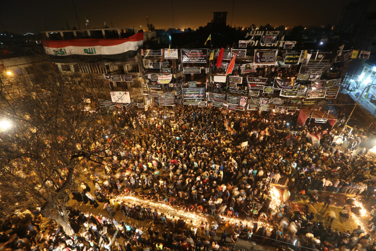 Image: People gather to pray at the scene of a massive truck bomb attack in Baghdad