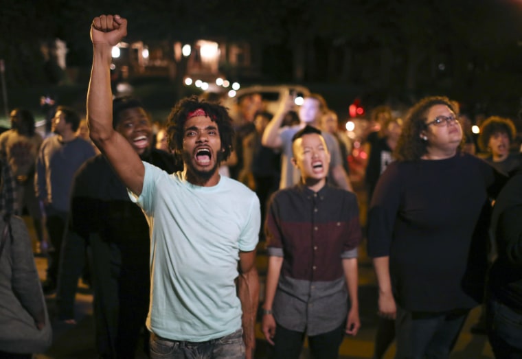 Image: Angry demonstrators chant as they block Summit Ave