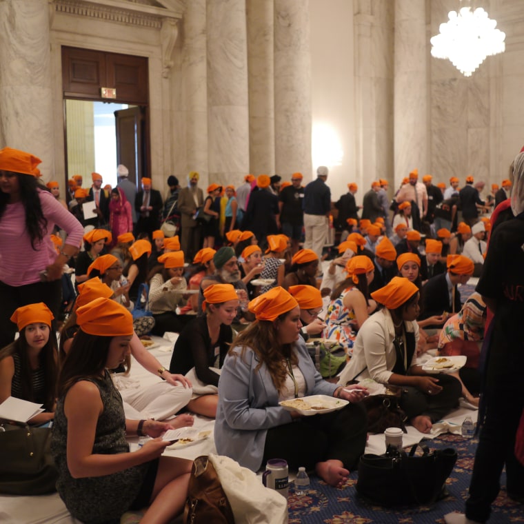 During langar, guests eat vegetarian meals sitting at the same level as each other and no one is turned away.