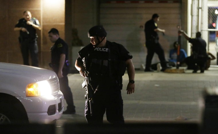 Image: Dallas police detain a driver after several police officers were shot in downtown Dallas