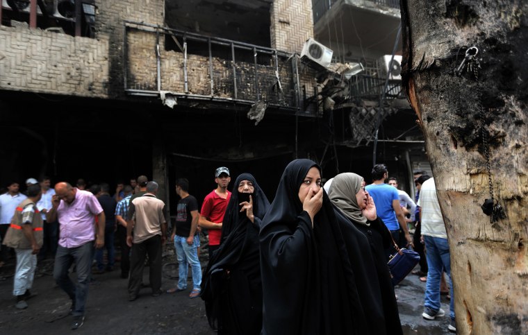 Image: Iraqi women wait to hear about family members who went missing after a car bomb hit Karada