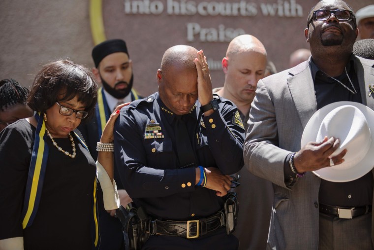 Image: Dallas Police Chief David Brown prays during a a vigil at Thanks-Giving square in Dallas