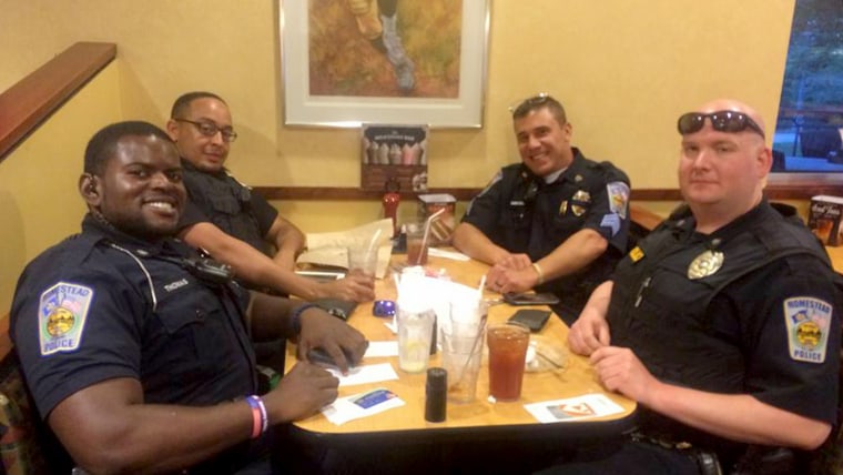 Officers pick up check for couple at restaurant