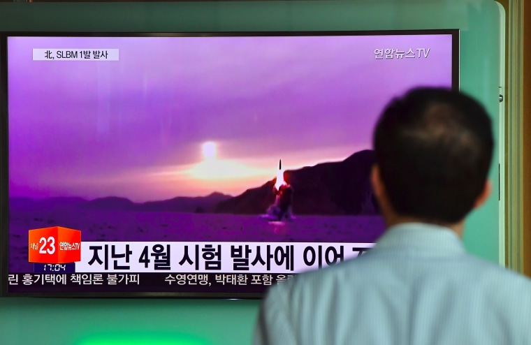 Image: A man watches file footage of a North Korean missile launch in Seoul on July 9, 2016