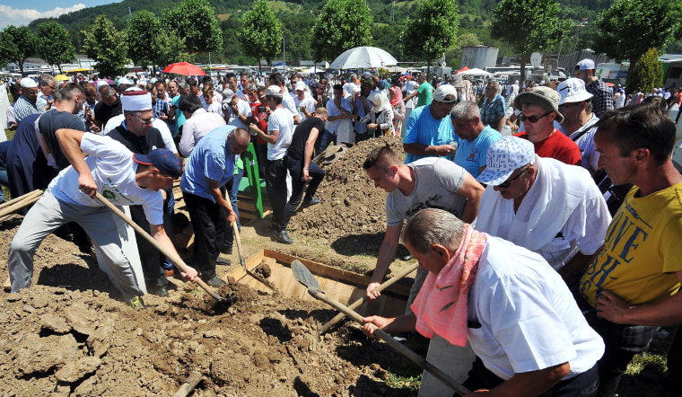 Image: Bosnian Muslims, survivors of Srebrenica 1995 massacre, bury body caskets with remains of their relatives