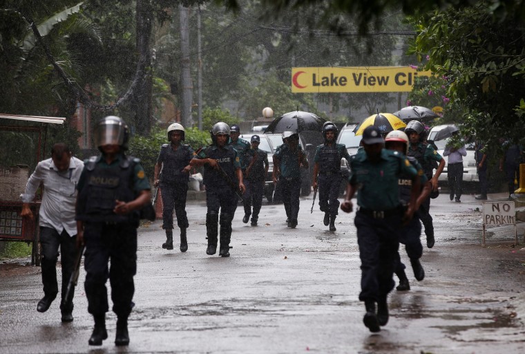 Image: Policemen patrol on the road leading to the Holey Artisan Bakery and the O'Kitchen Restaurant after gunmen attacked, in Dhaka