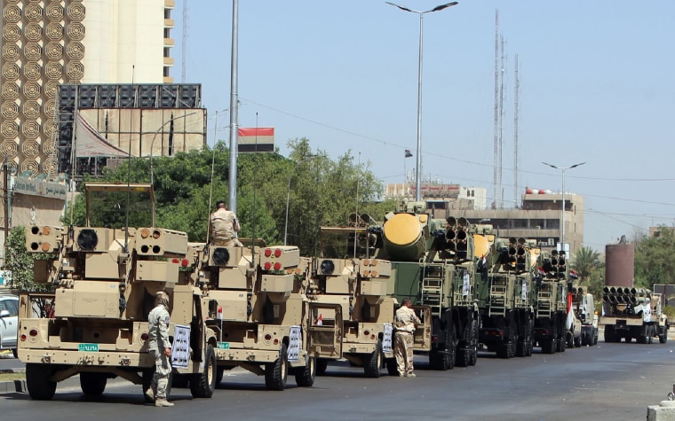 Image: Iraqi pro-government forces take part in a rehearsal for a military parade in the streets of Baghdad