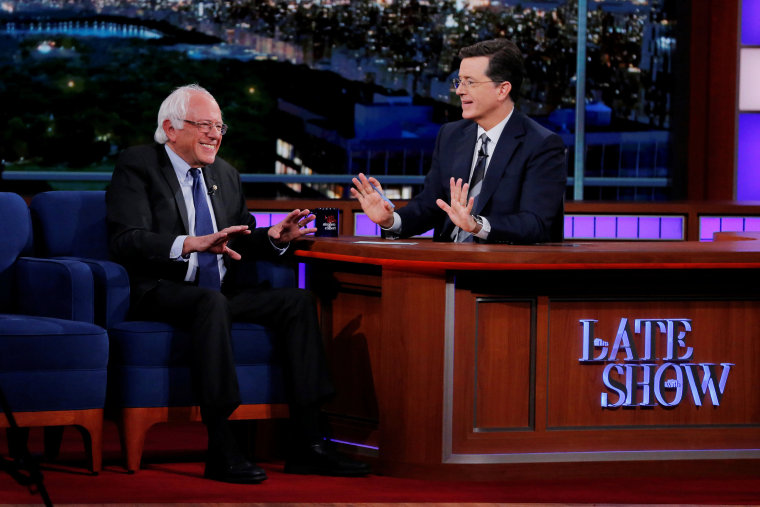 Image: U.S. Democratic presidential candidate Bernie Sanders greets \"The Late Show\" host Stephen Colbert during a taping of the show in the Manhattan borough of New York