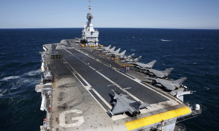 Image: File photo of Rafale and Super Etendards fighter jets are parked prior to a mission aboard France's Charles de Gaulle aircraft carrier sailing in the Gulf