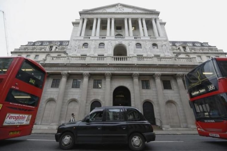 A taxi and buses queue outside the Bank of England in London, Britain