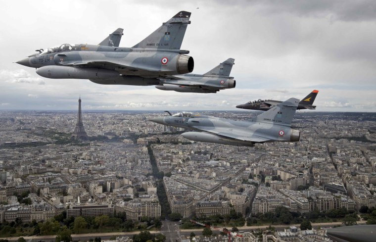 Image: Four Mirage 2000C and one Alpha jet flight over Paris on their way to participate in the Bastille Day military parade