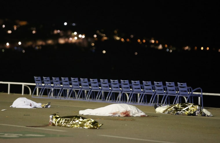 Image: Bodies are seen on the ground after a heavy truck ran into a crowd at high speed killing scores celebrating the Bastille Day July 14 national holiday on the Promenade des Anglais in Nice