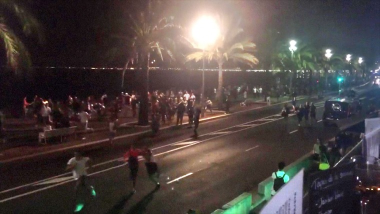 Image: People run away from the scene of an attack in the French Riviera city of Nice.