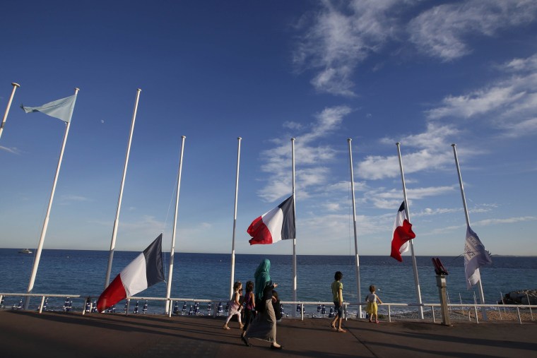 Image: French flags fly at half-mast in memory of victims the day after a truck ran into a crowd at high speed killing scores and injuring more who were celebrating the Bastille Day national holiday, in Nice