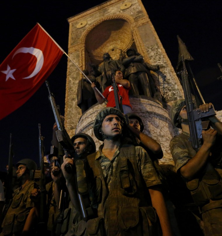 Image: People demonstrate in front of the Republic Monument at the Taksim Square in Istanbul