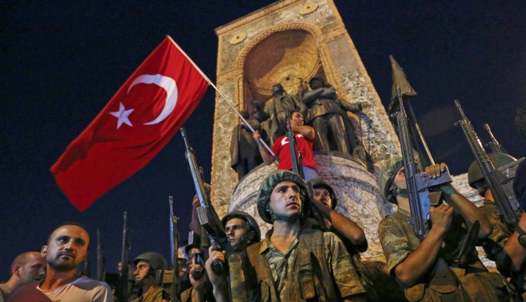 Image: People demonstrate in front of the Republic Monument at the Taksim Square in Istanbul