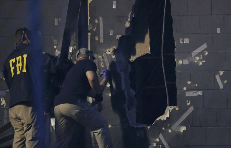 Image: Police forensic investigators work at the crime scene of a mass shooting at the Pulse gay night club in Orlando