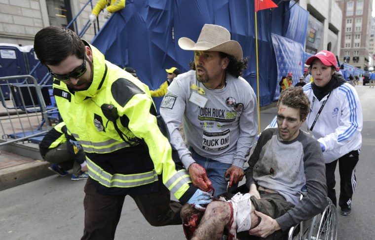 Carlos Arredondo in the cowboy hat, pushes Jeff Bauman