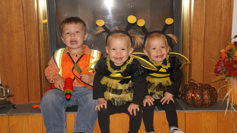 The girls with their big brother, Jaxon, 3, on Halloween.