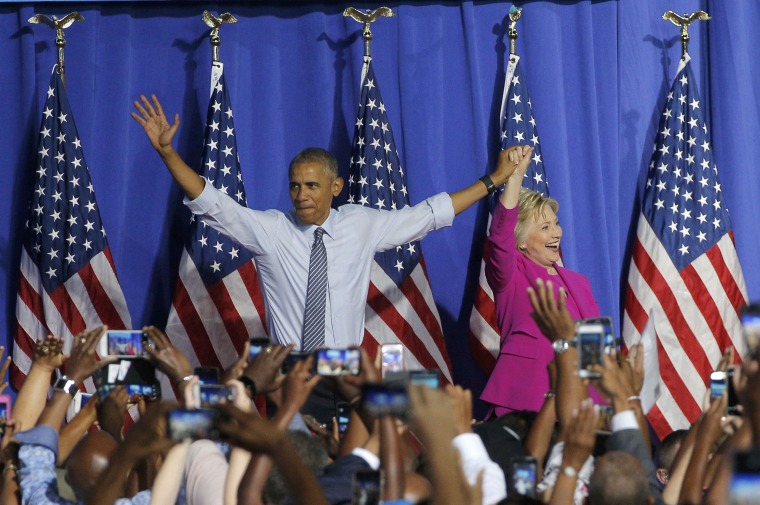 Image: U.S. President Obama waves with Democratic U.S. presidential candidate Clinton at campaign event in Charlotte, North Carolina