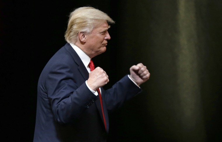 Image: Donald Trump pumps his fists during a rally in Raleigh