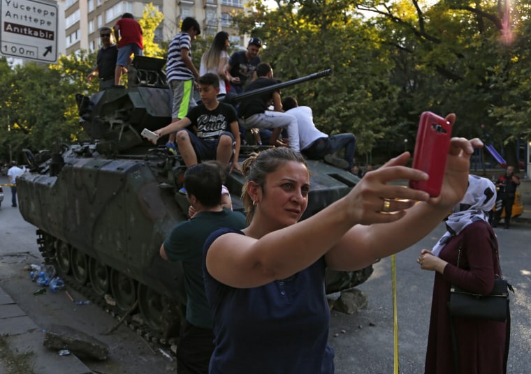 Image: Woman takes a self near Turkish military vehicle on July 16, 2016