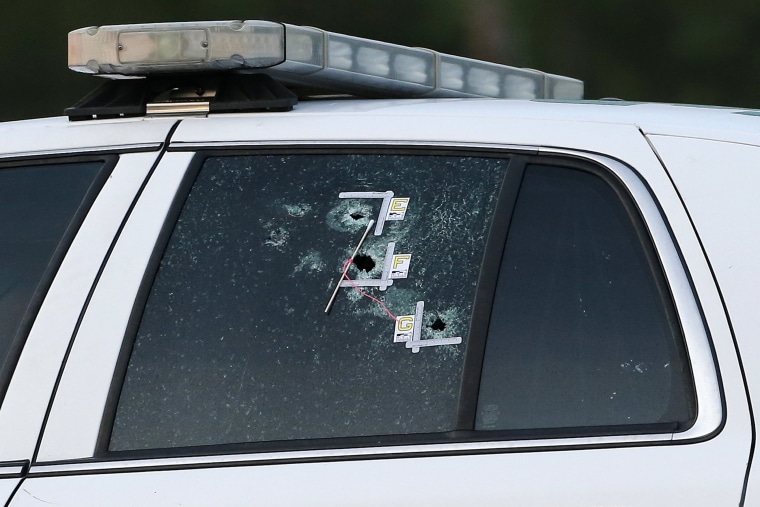 Image: An East Baton Rouge Sheriff vehicle is seen with bullet holes in its windows near the scene where police officers were shot, in Baton Rouge, Louisiana