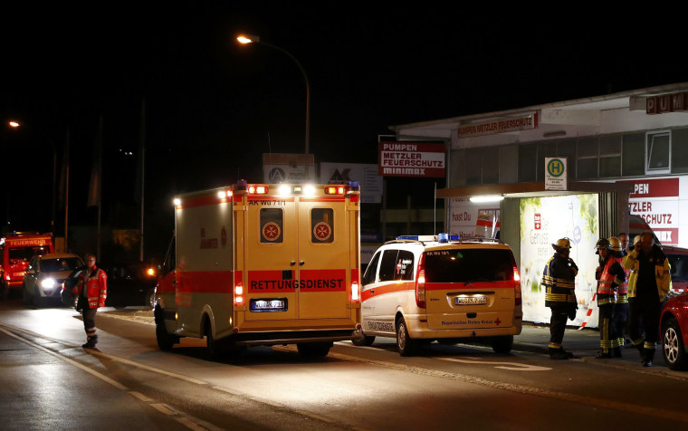 Image: German emergency services workers work in the area where a man with an axe attacked passengers on a train