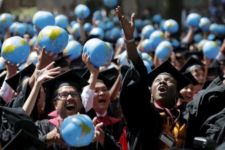 Olufunke Michaels and her classmates celebrate after receiving their degrees from the John F. Kennedy School of Government during the 364th Commencement Exercises at Harvard University in Cambridge