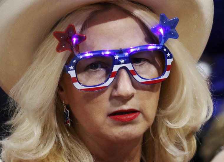 Image: A delegate with illuminated glasses waits for the session to begin at the Republican National Convention in Cleveland