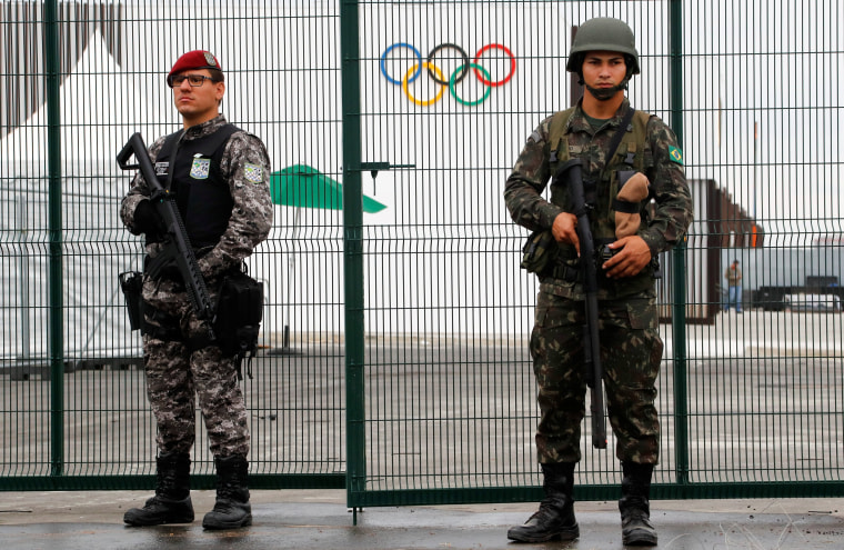 Image: Brazilian Public-Safety National Force and military police soldiers guard an entrance at the security fence outside the 2016 Rio Olympics Park in Rio de Janeiro