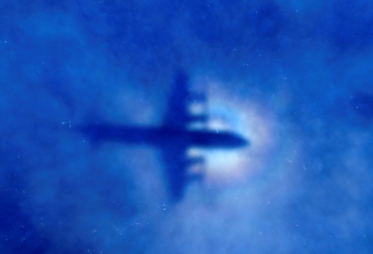 Image: The shadow of a Royal New Zealand Air Force (RNZAF) P3 Orion maritime search aircraft can be seen on low-level clouds as it flies over the southern Indian Ocean looking for missing Malaysian Airlines flight MH370