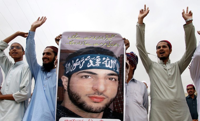 Image: Protesters hold portraits of Burhan Wani