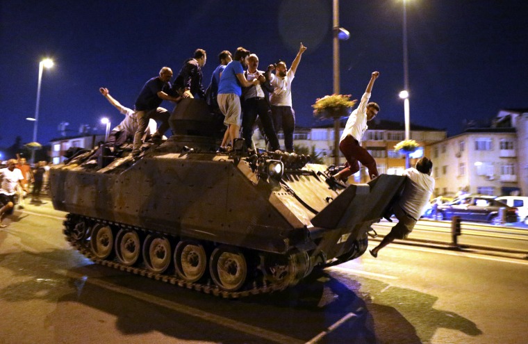 Image: People ride a tank in Istanbul, Turkey,