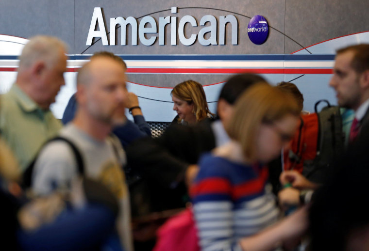 Image: Travelers line up at an American Airlines ticket counter at O'Hare Airport in Chicago