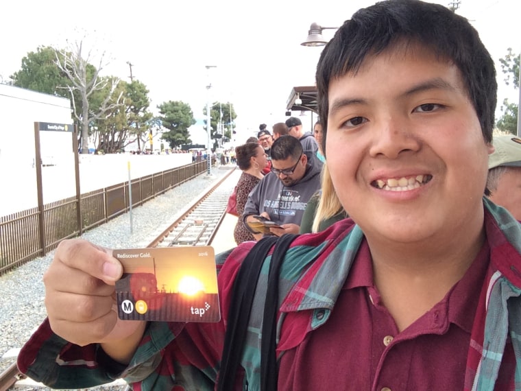 Kenny Uong holds up a special edition TAP card commemorating the extension of the Metro Gold Line.