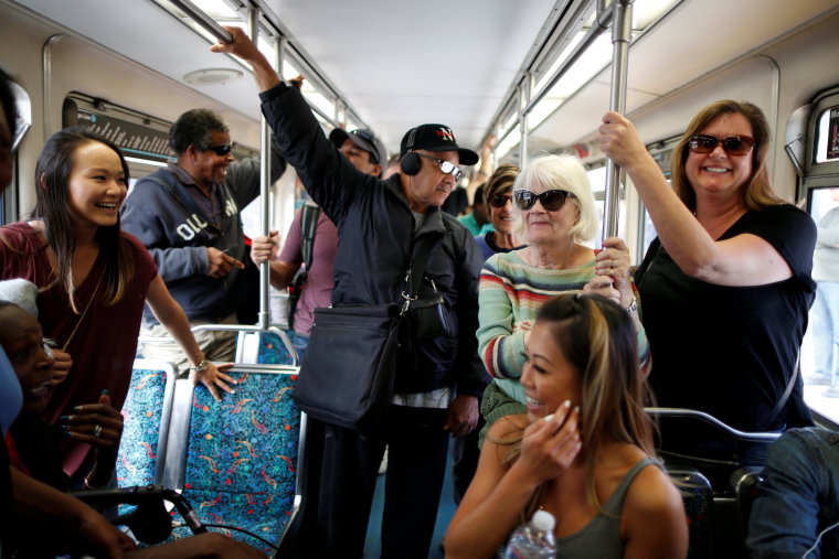 Image: People ride a train on L.A. Metro's new $1.5 billion Expo Line extension that connects downtown to the beach for the first time in 63 years, in Santa Monica