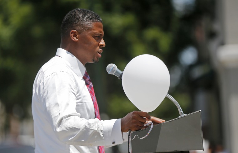 Former NFL running back Warrick Dunn speaks at a noon vigil organized by municipal court workers in downtown Baton Rouge, Louisiana, on July 20, in honor of recently slain and injured police officers.