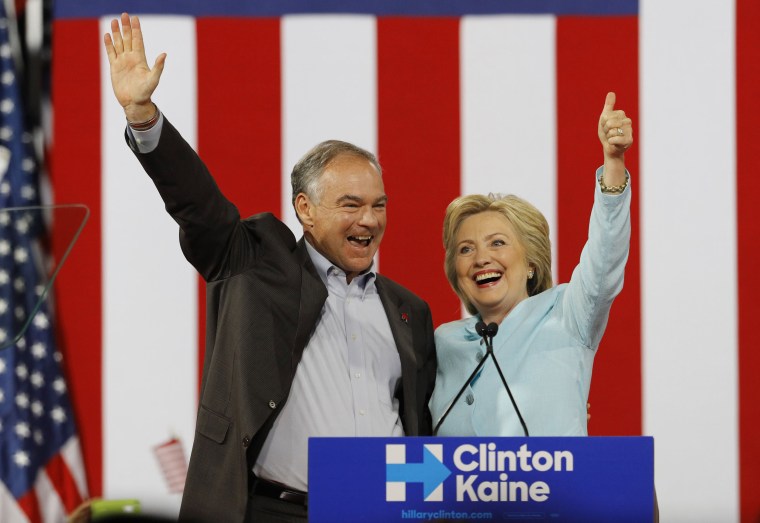 Image: Democratic U.S. vice presidential candidate Kaine waves with his presidential running-mate Clinton after she introduced him during a campaign rally in Miami