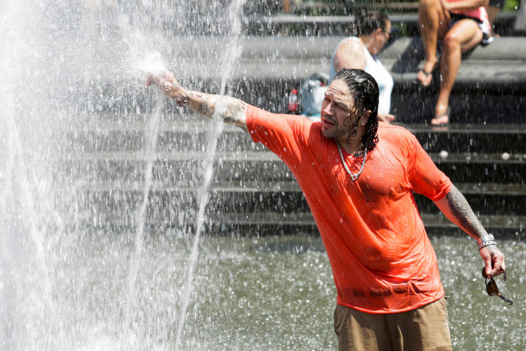 Image: A man cools off himself on a fountain during a heat wave called "Heat Dome" in the Manhattan borough of New York, U.S.