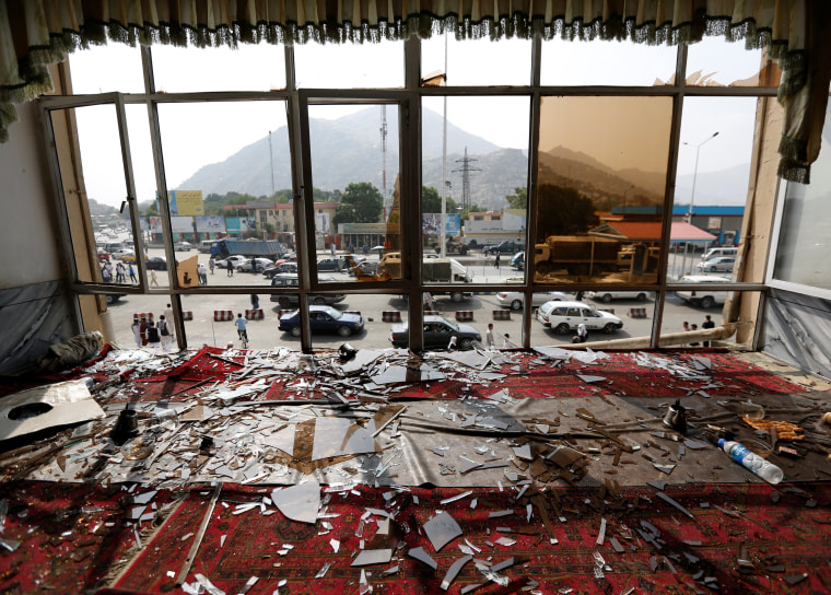 Image: Broken glass and debris are seen inside a resturant a day after a suicide attack in Kabul