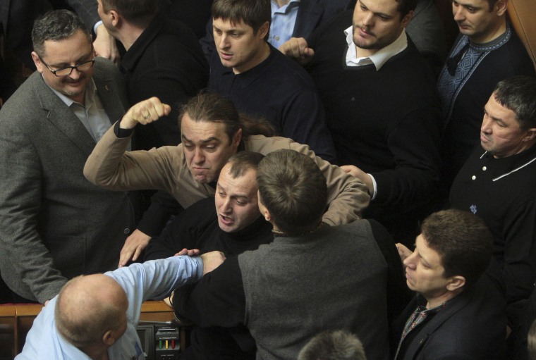 Image: Ukrainian deputies fight during a session of parliament in Kiev